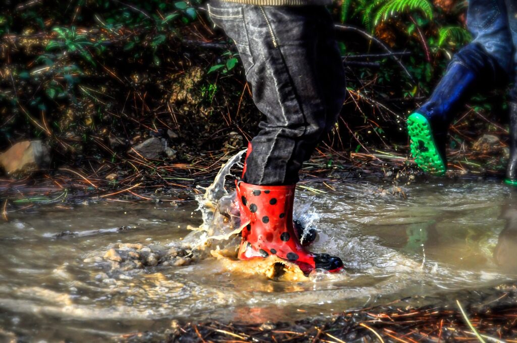 splashing in puddle with rubber boots