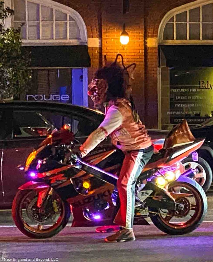 Person wearning Monster Mask on Motorcycle in Salem, MA