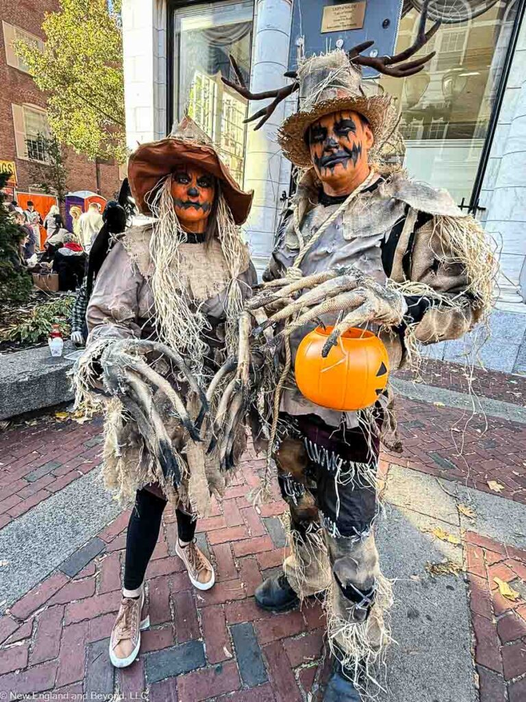 People dressed as pumpkin scarecrows in Salem. MA